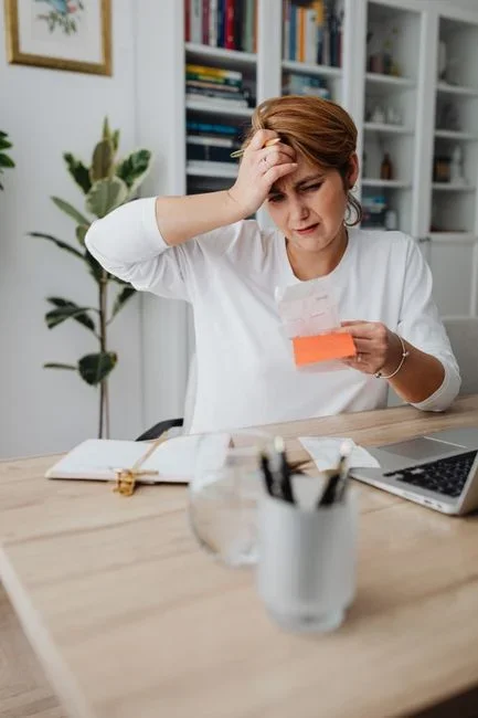 Person looking confused at a billing statement on a laptop