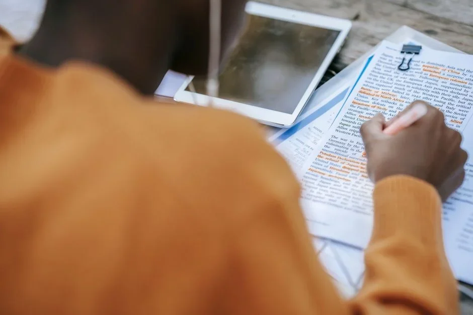 Person quickly scanning a document on a tablet, highlighting key sections
